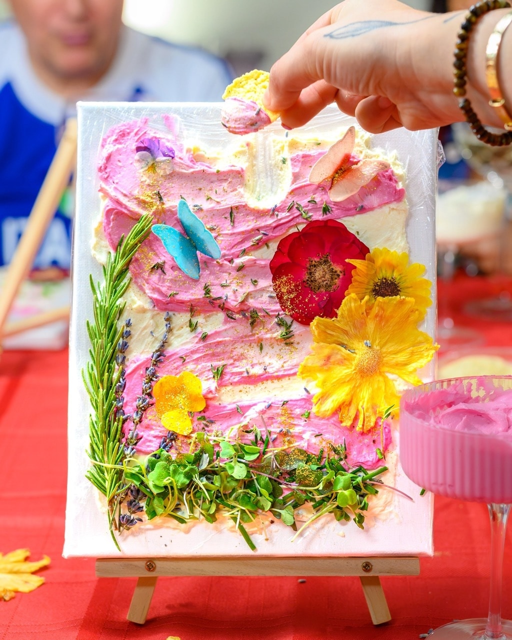 Hands-on edible art canvas with vibrant flowers, herbs and spreadable cheese